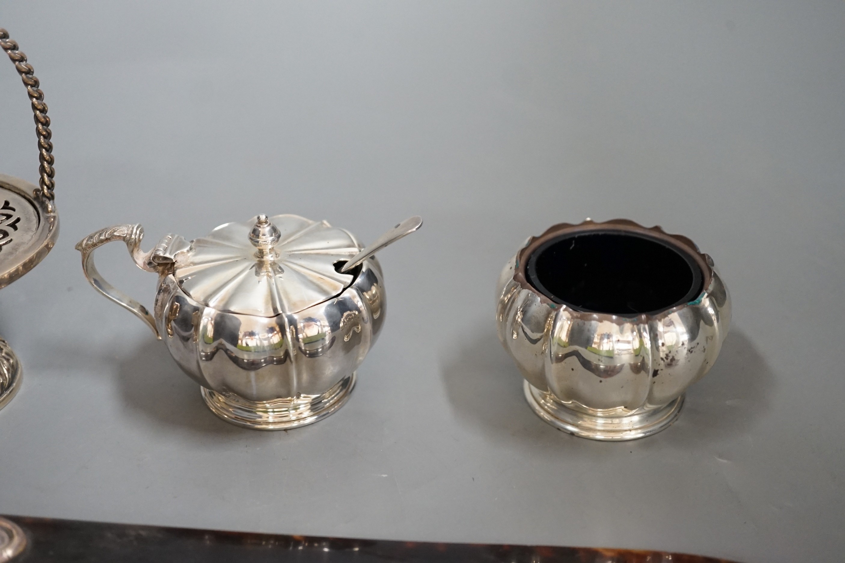 A white metal handled tortoiseshell paper knife and sundry small silver items, including an Edwardian pot pourri basket and two silver condiments by Elkington & Co.